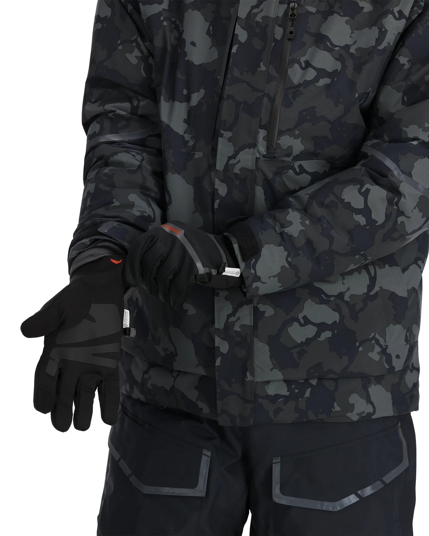 Person wearing a black camouflage jacket and gloves on a white background