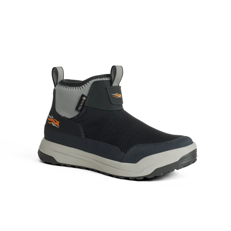 Black and gray shoe with orange logo on a white background