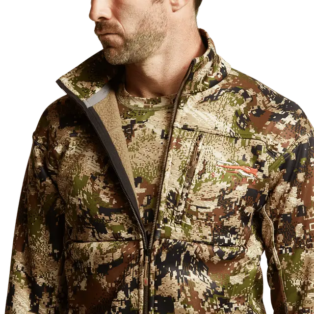 Man wearing a camouflage jacket on a white background