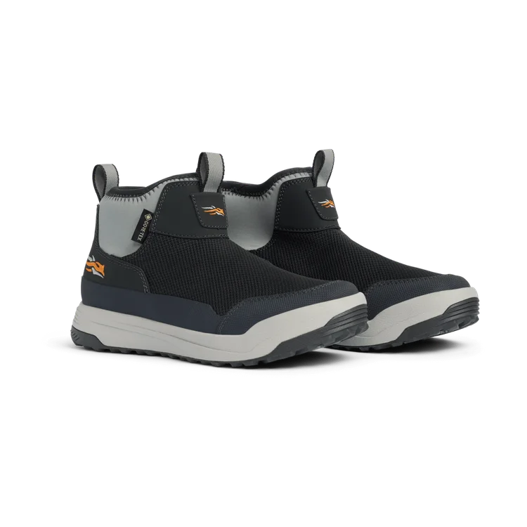 Black and gray slip-on shoes with a white sole on a white background