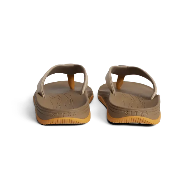 Pair of brown sandals with visible brand name on a white background