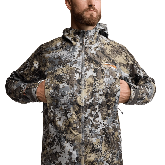 Man wearing a camouflage jacket on a white background