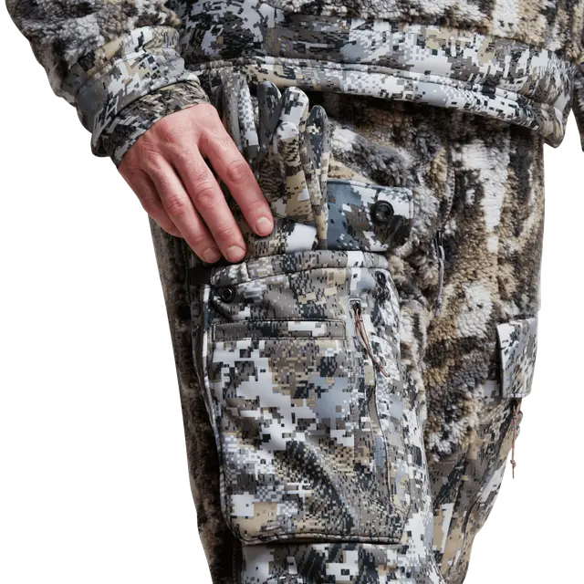 Man wearing camouflage bibs on a white background