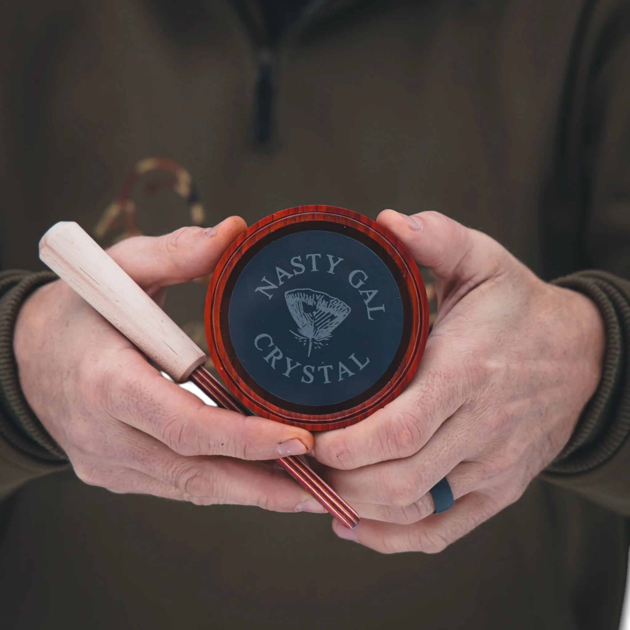 Person holding a hair product container with 'Nasty Gal Crystal' branding.