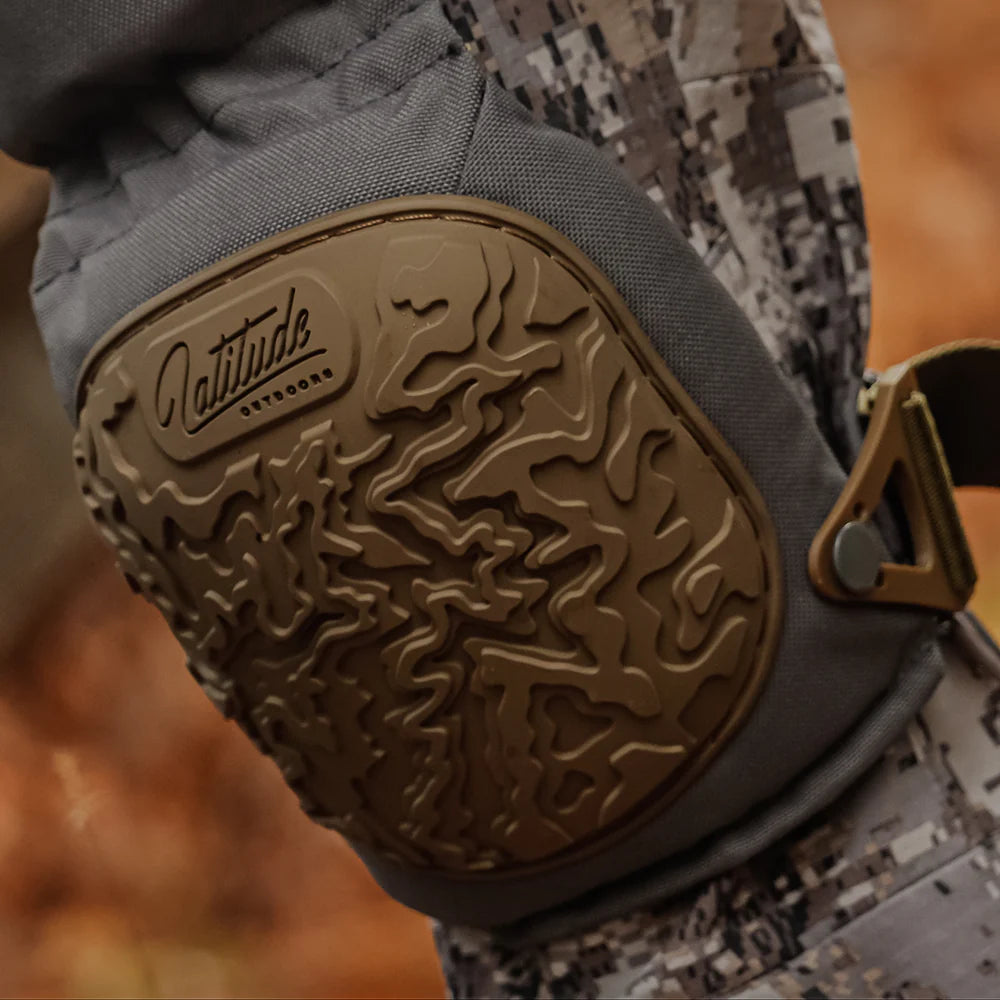 Close-up of a textured glove with 'Latitude' branding on a blurred background