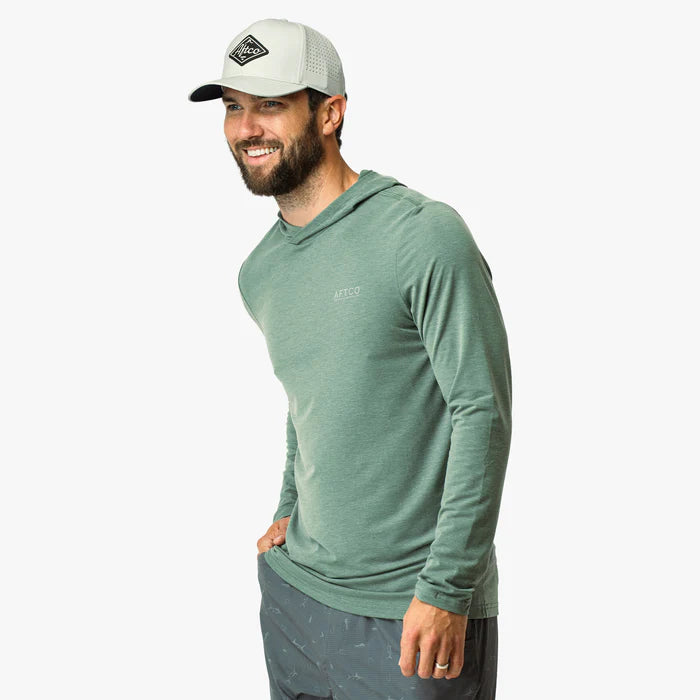 Man wearing a green long-sleeve shirt and gray cap on a white background