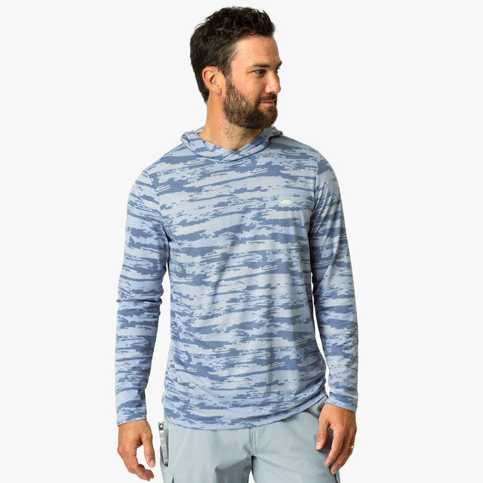 Person wearing blue camouflage hoodie on a white background