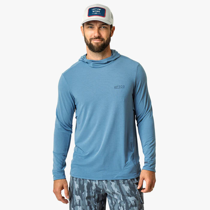 Man wearing a blue hoodie with a logo on a white background
