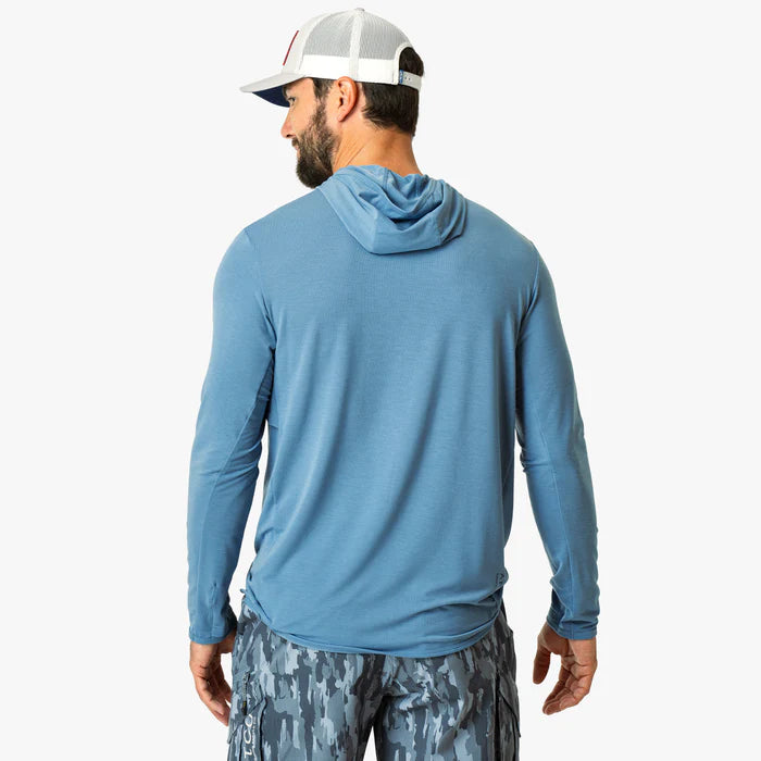 Man wearing a blue long-sleeve shirt with a hood on a white background
