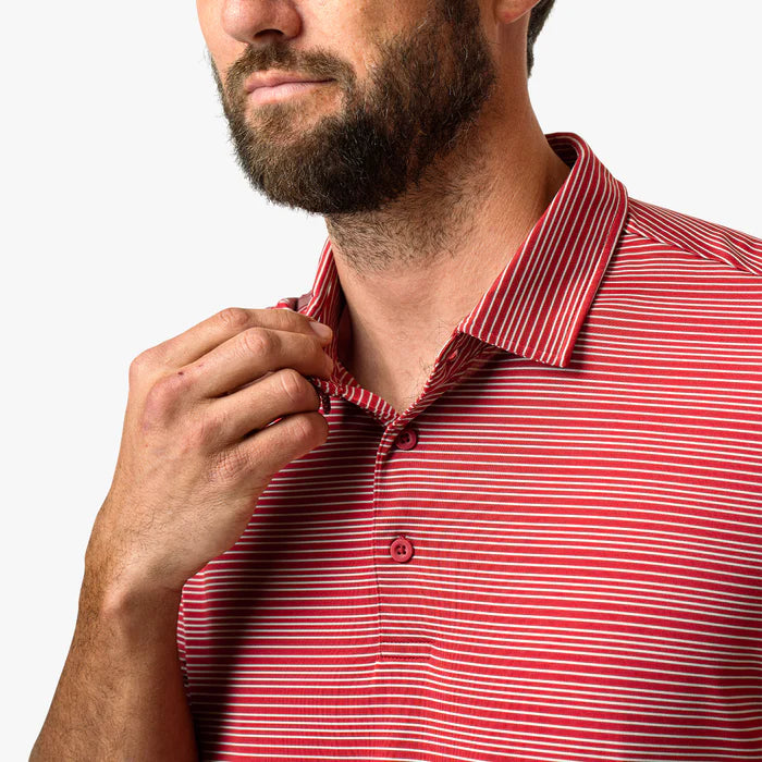 Man wearing a red and white striped polo shirt against a white background