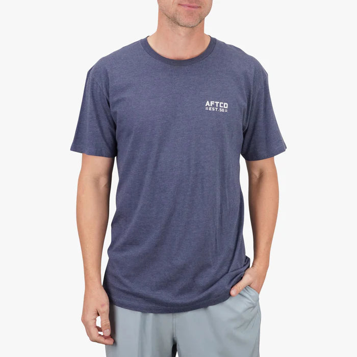 person wearing a blue shirt with visible logo on white background