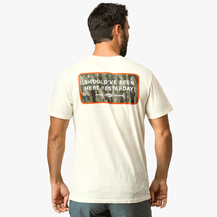 man wearing white shirt with logo on a white background