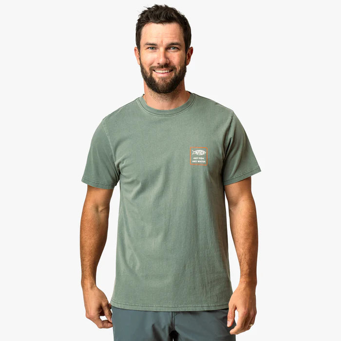 man wearing green shirt with logo on a white background