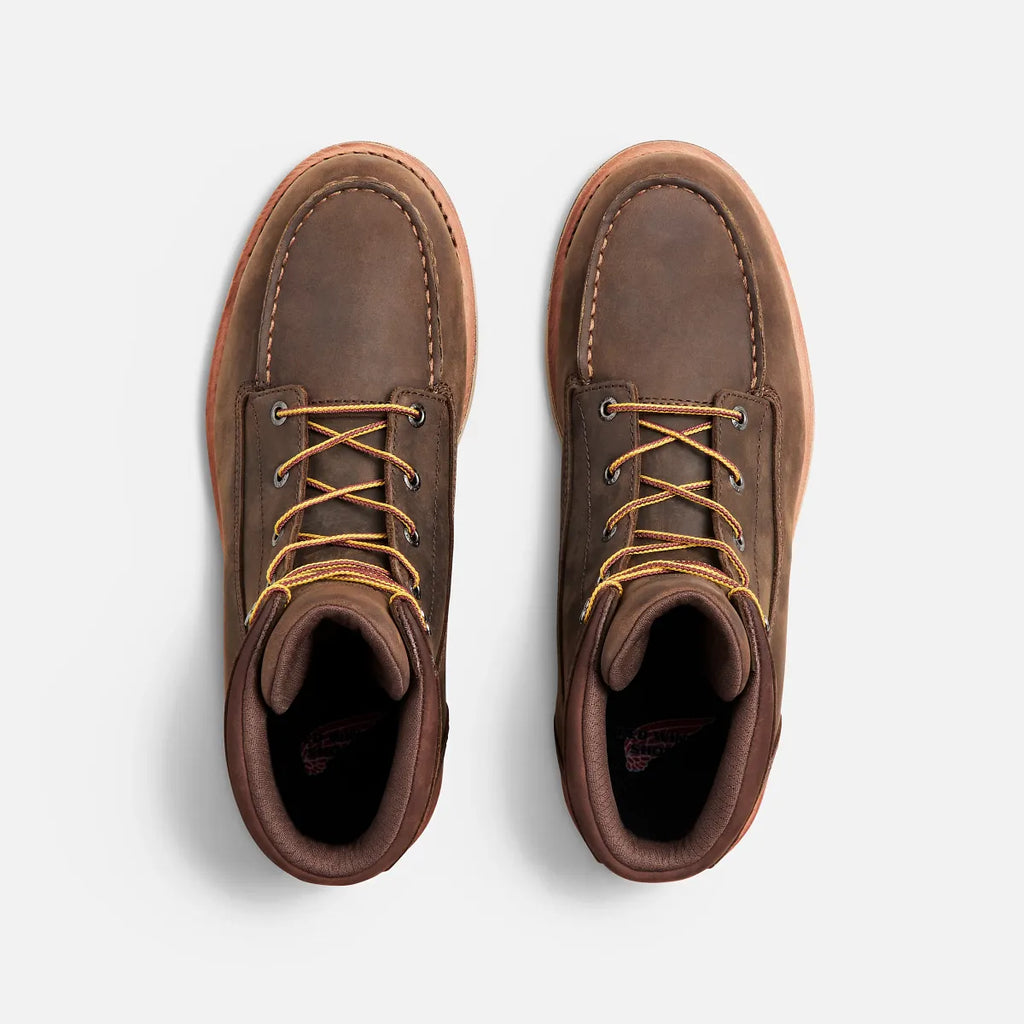 Pair of brown leather boots on a light gray background