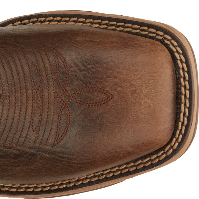 Close-up of a brown leather boot with stitching detail on a white background