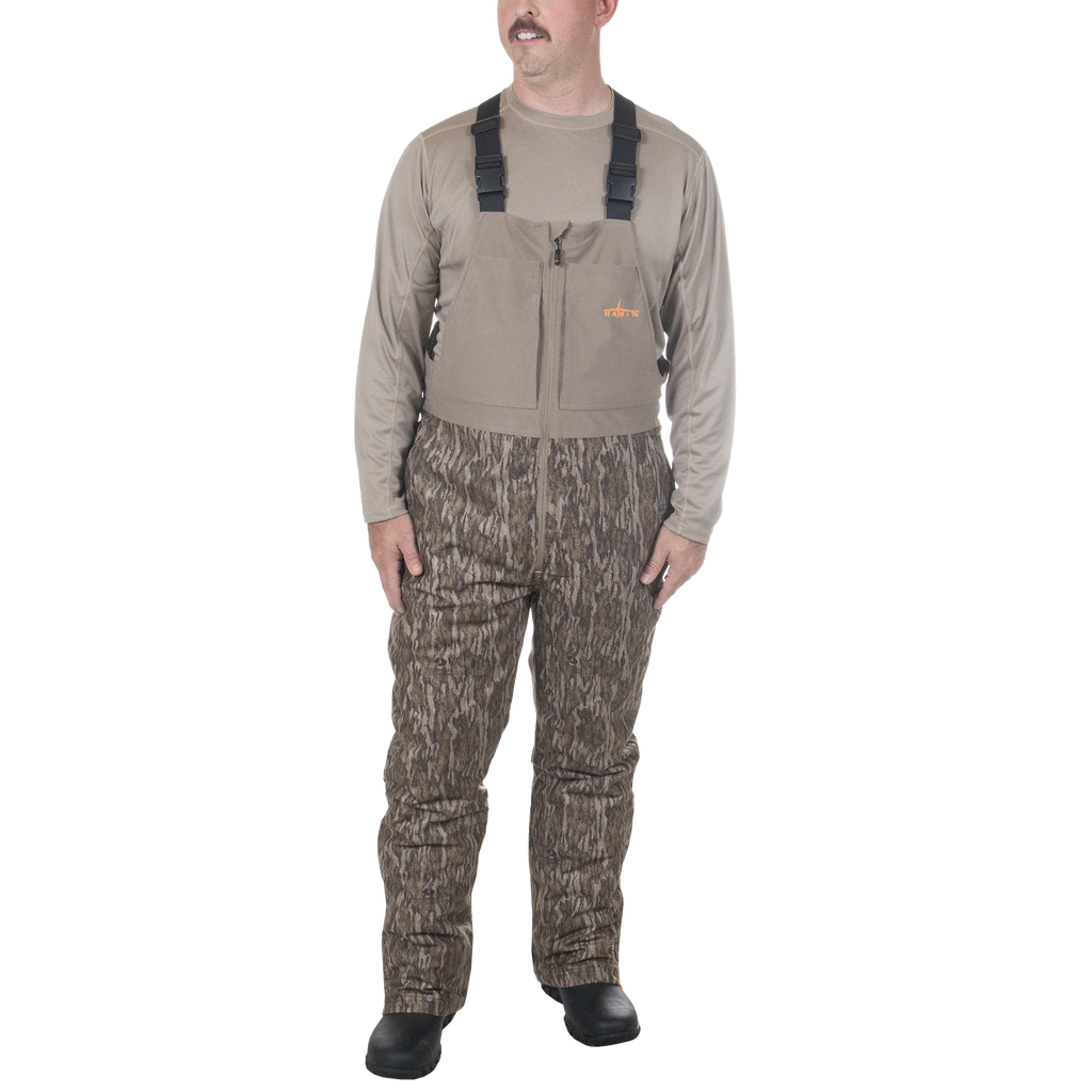 Man wearing a hunting outfit with a vest and camouflage pants on a white background