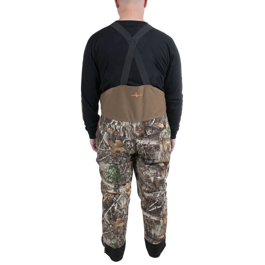 Man wearing camouflage hunting pants and a brown vest on a white background
