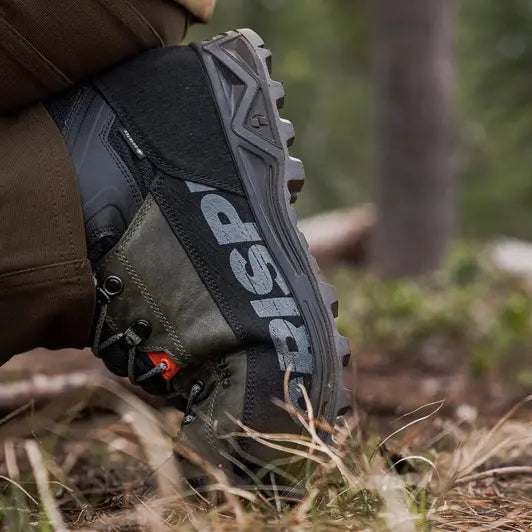 Close-up of a hiking boot with 'Crispi' branding in a natural setting.