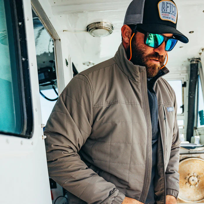 Man wearing a cap and sunglasses inside a vehicle