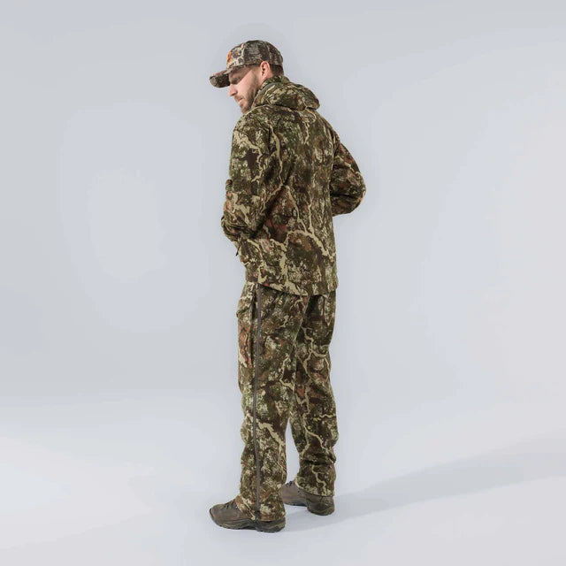 Person wearing a full camouflage outfit on a white background
