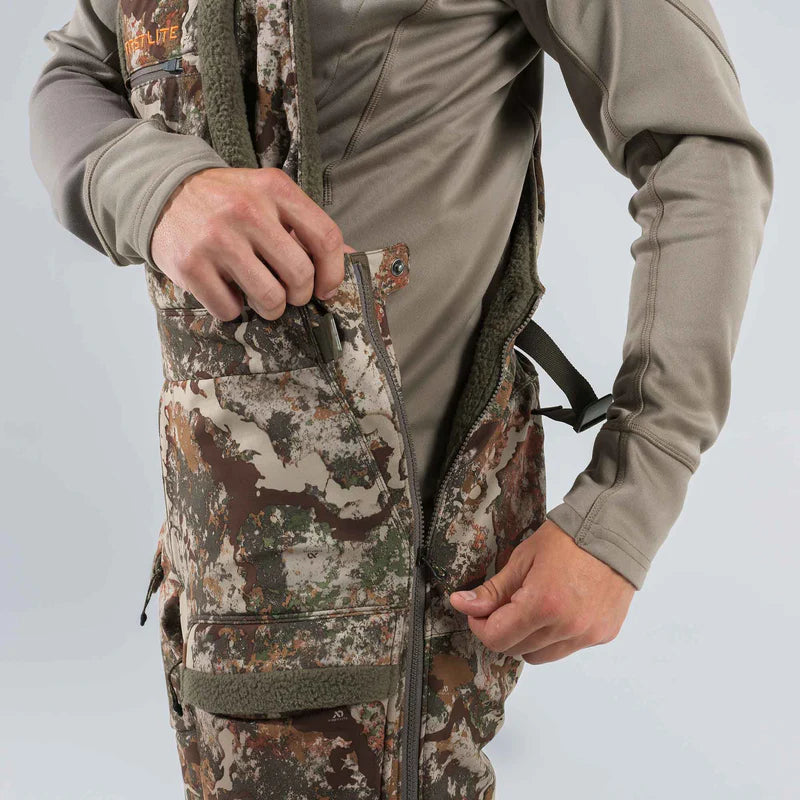Person wearing camouflage hunting gear with a gray shirt on a light gray background