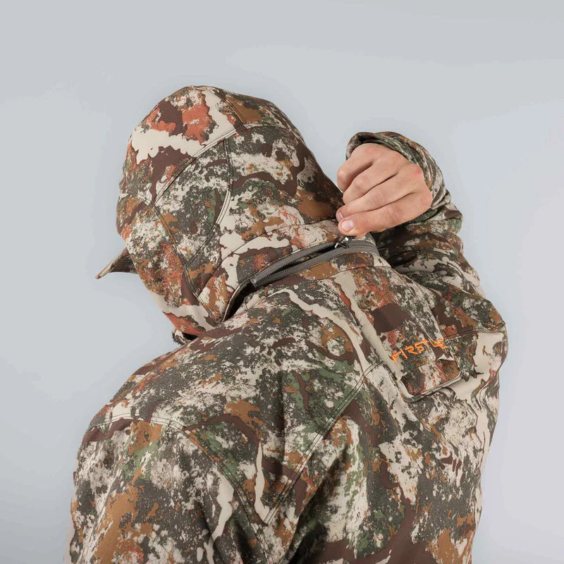 Camouflage jacket with hood on a plain background