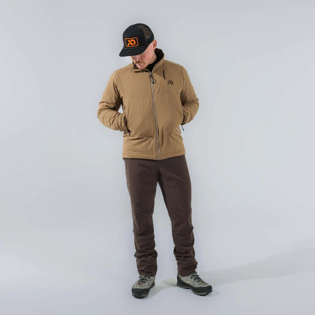 Person wearing a brown jacket, brown pants, and a black cap with a logo on a white background