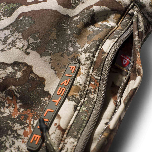 Camouflage jacket with a visible brand logo on a neutral background