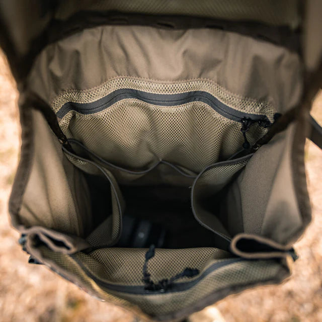 Open backpack showing interior compartments on a natural background